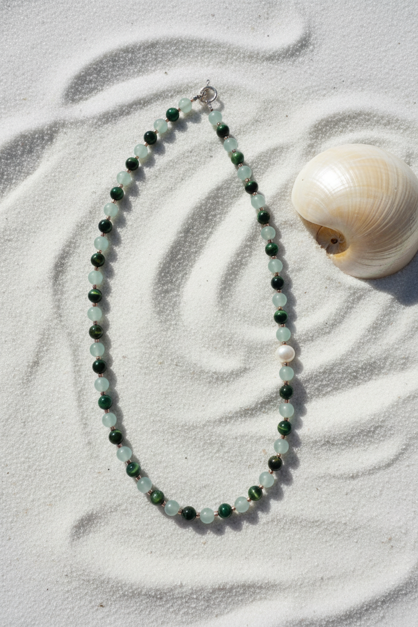 Necklace close-up on white sandy beach
