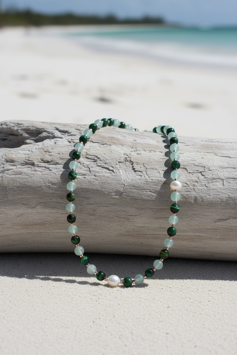 Necklace draped over driftwood