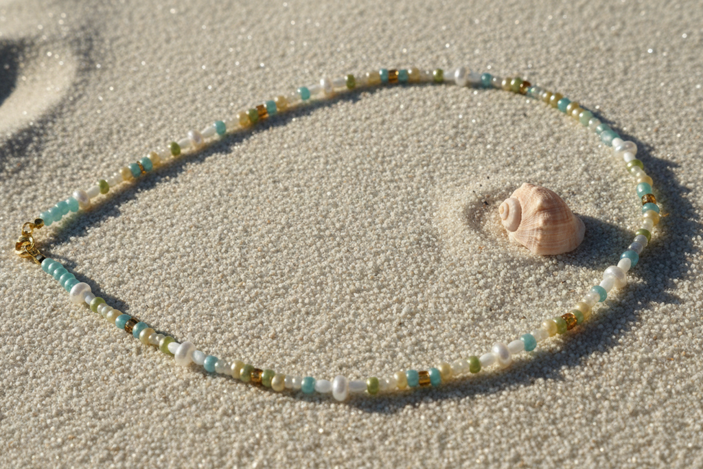 Necklace on white sandy beach